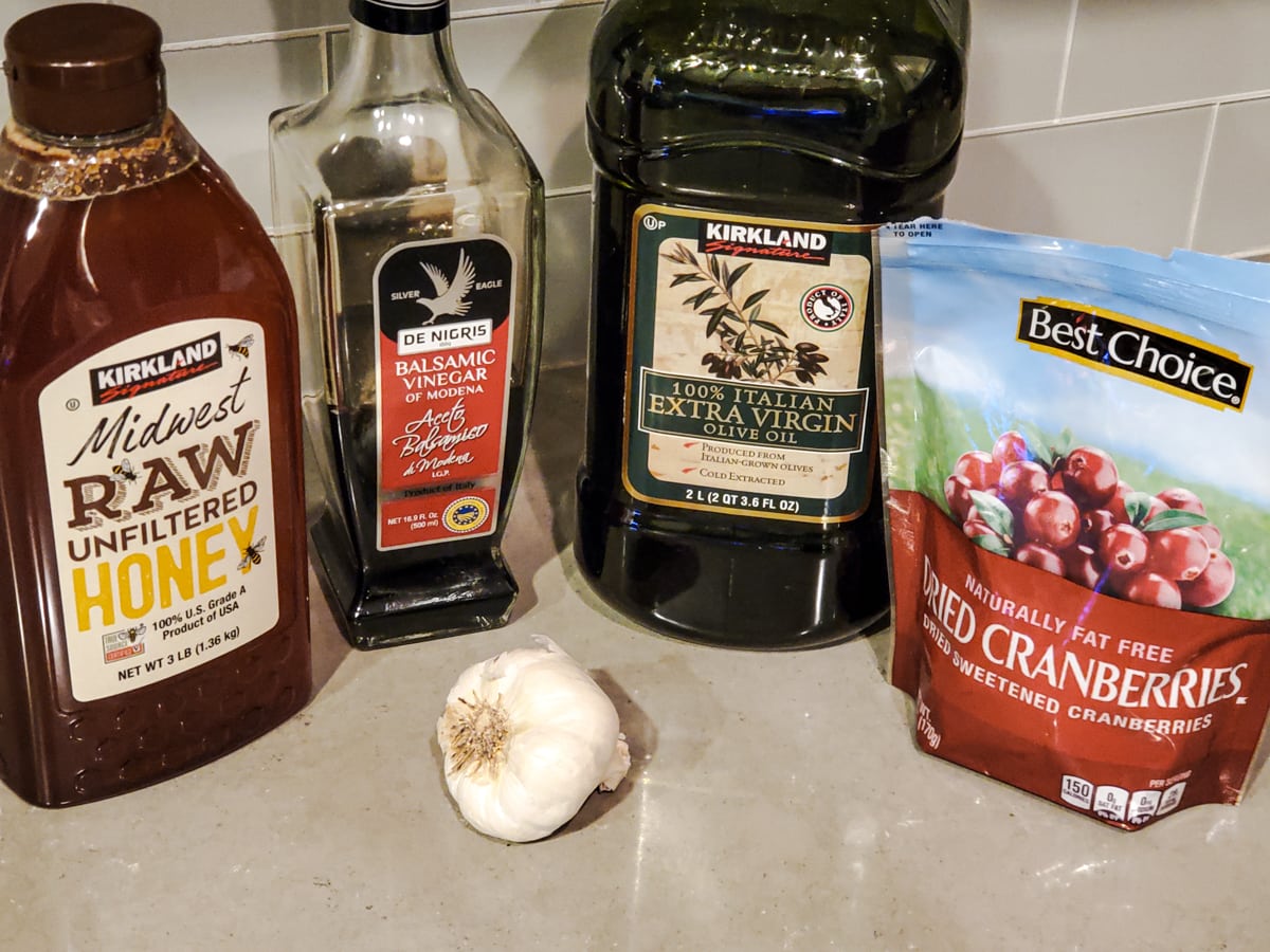 Ingredients for a cranberry balsamic vinaigrette on a counter.