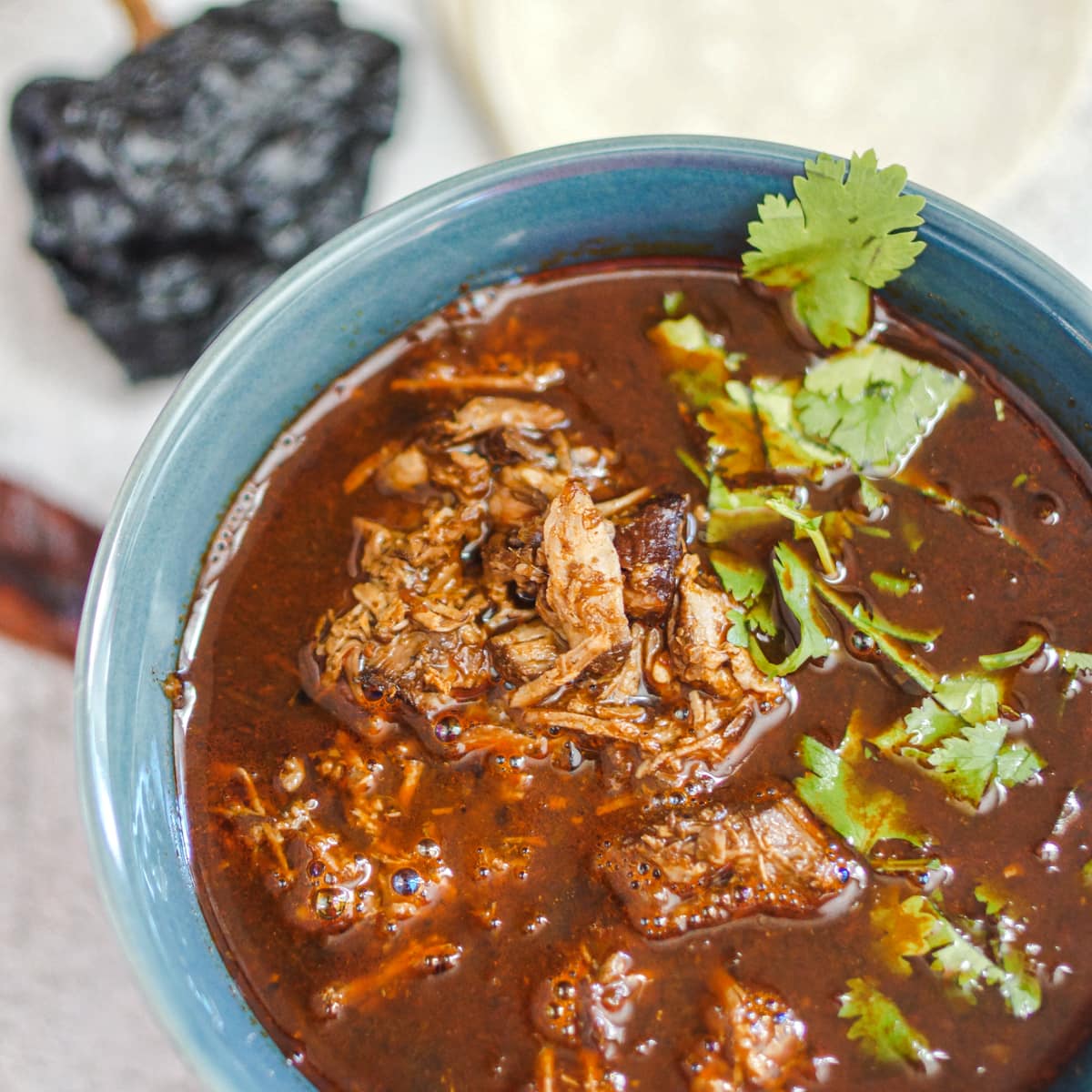 Authentic Mexican birria in a bowl with lamb and homemade consume.