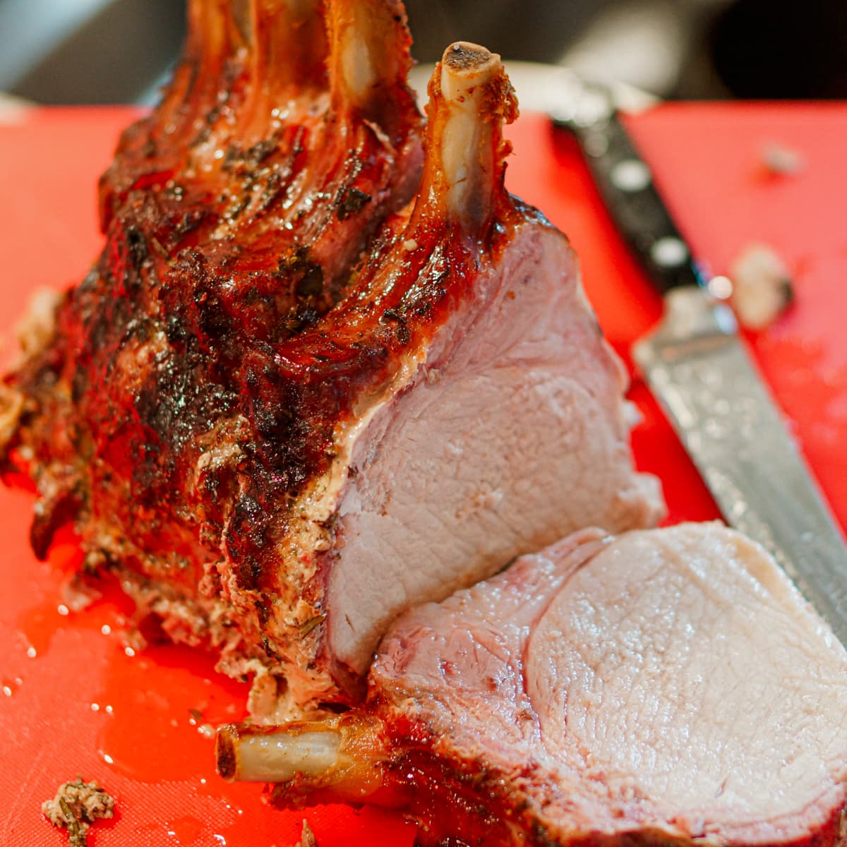 Smoked pork crown roast on a cutting board.