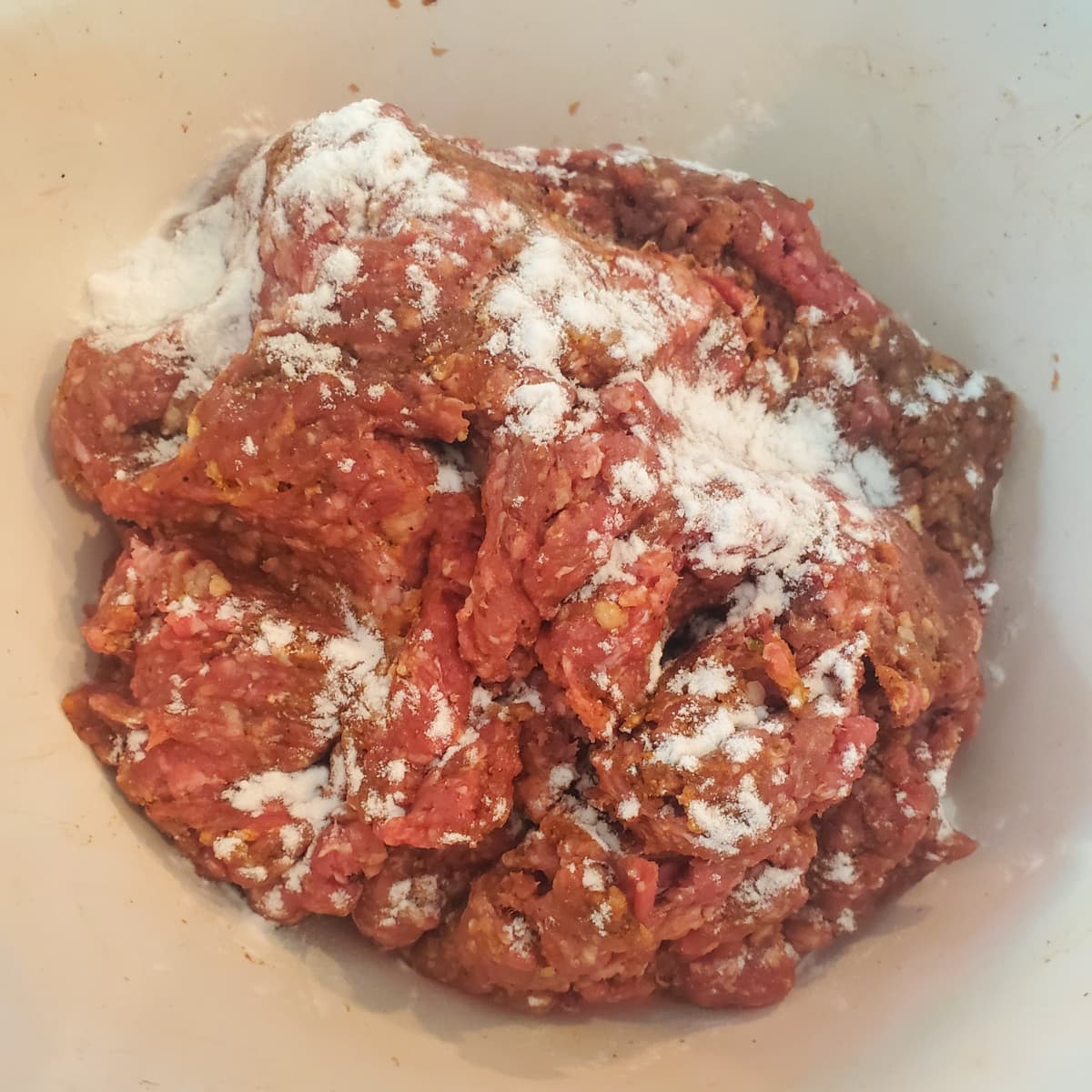 Ground meat for cevapi, dusted with baking soda.