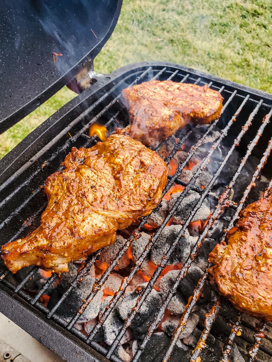 Kansas City bone in pork chops on a grill.