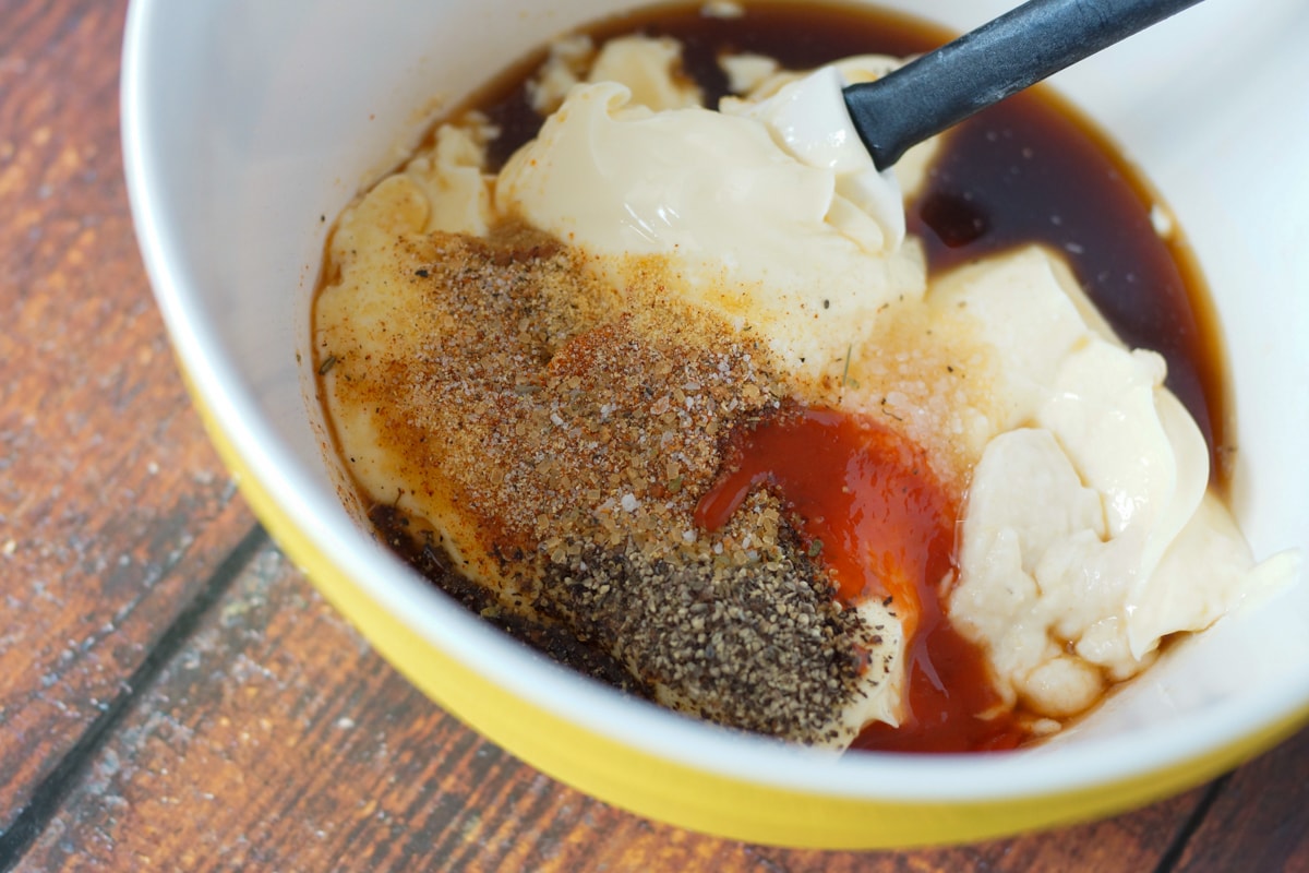 Ingredients for white BBQ sauce being mixed in a bowl.