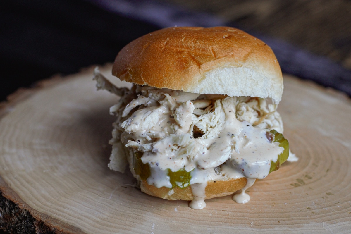 Pulled chicken sandwich with a zesty white BBQ sauce.