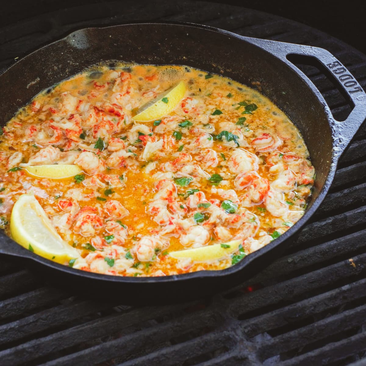 Crawfish sautéing in a Cast iron pan on a Big Green Egg. 