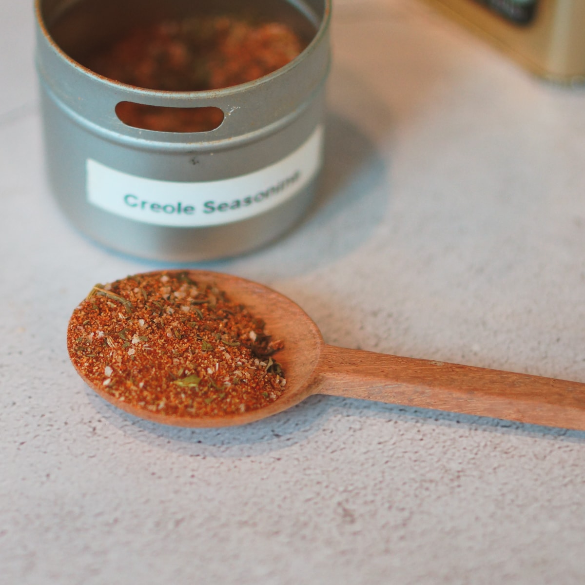 Wooden spoon with homemade Cajun seasoning.