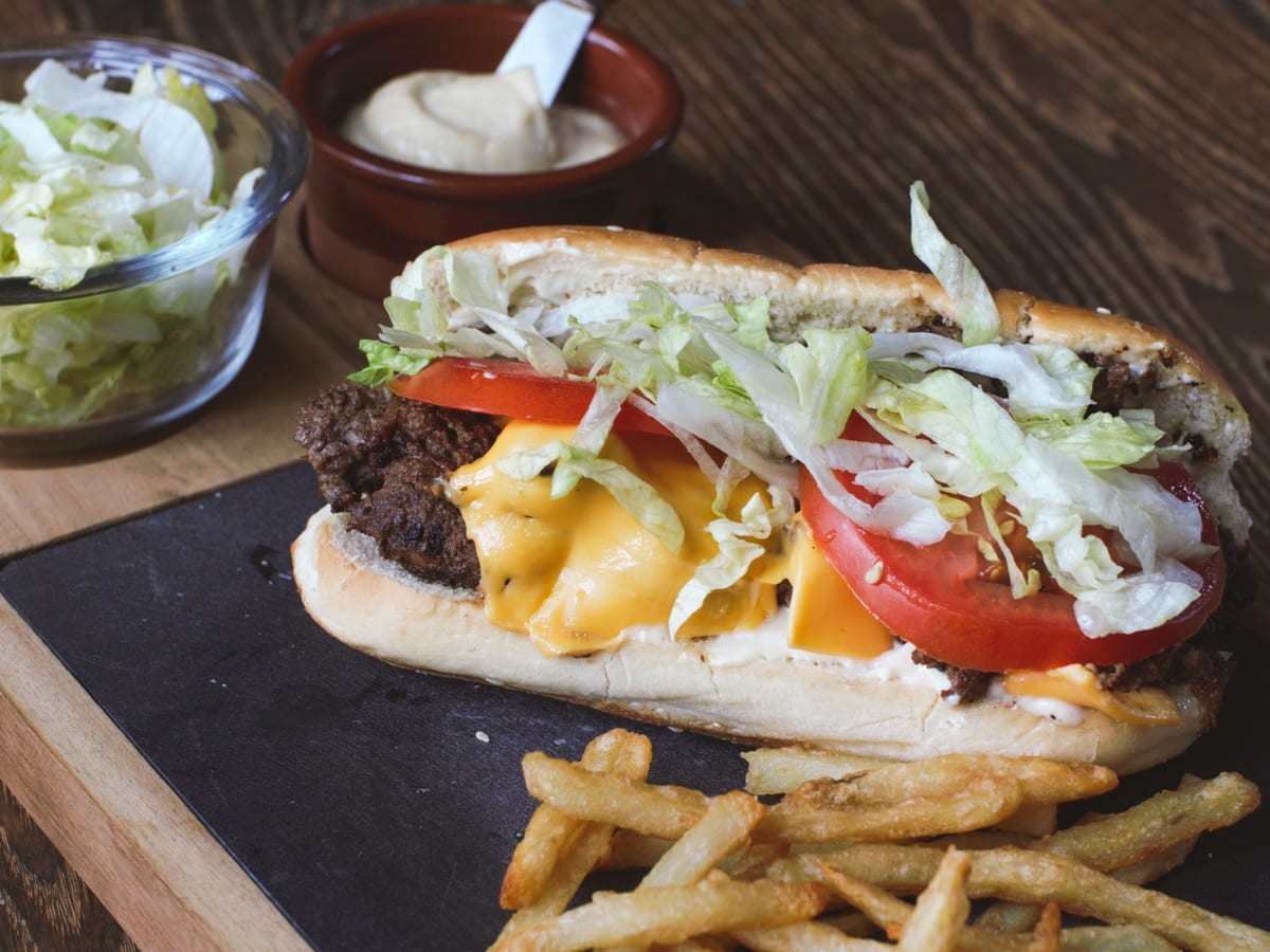 New York Style Chopped Cheese Sandwich with American cheese, tomato, lettuce, and French fries.
