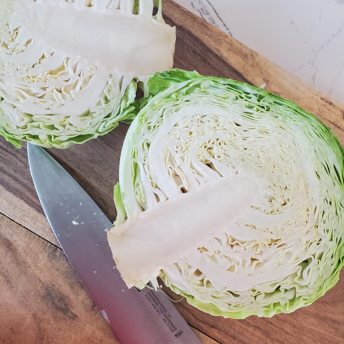 Head of green cabbage cut in half.