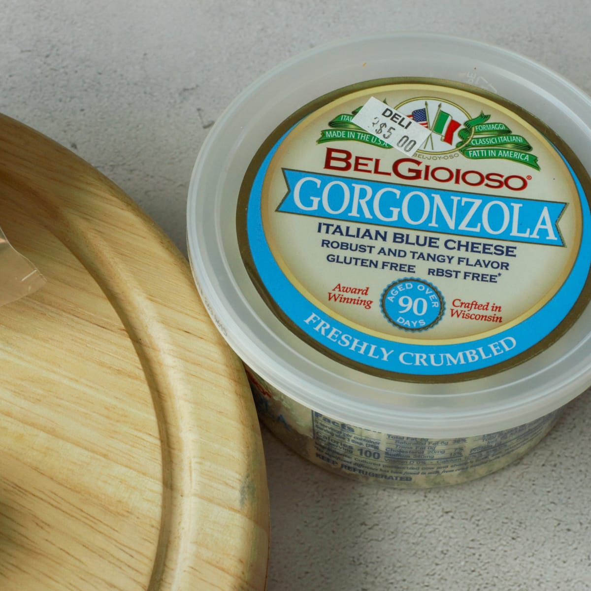 Tub of crumbled Gorgonzola cheese.