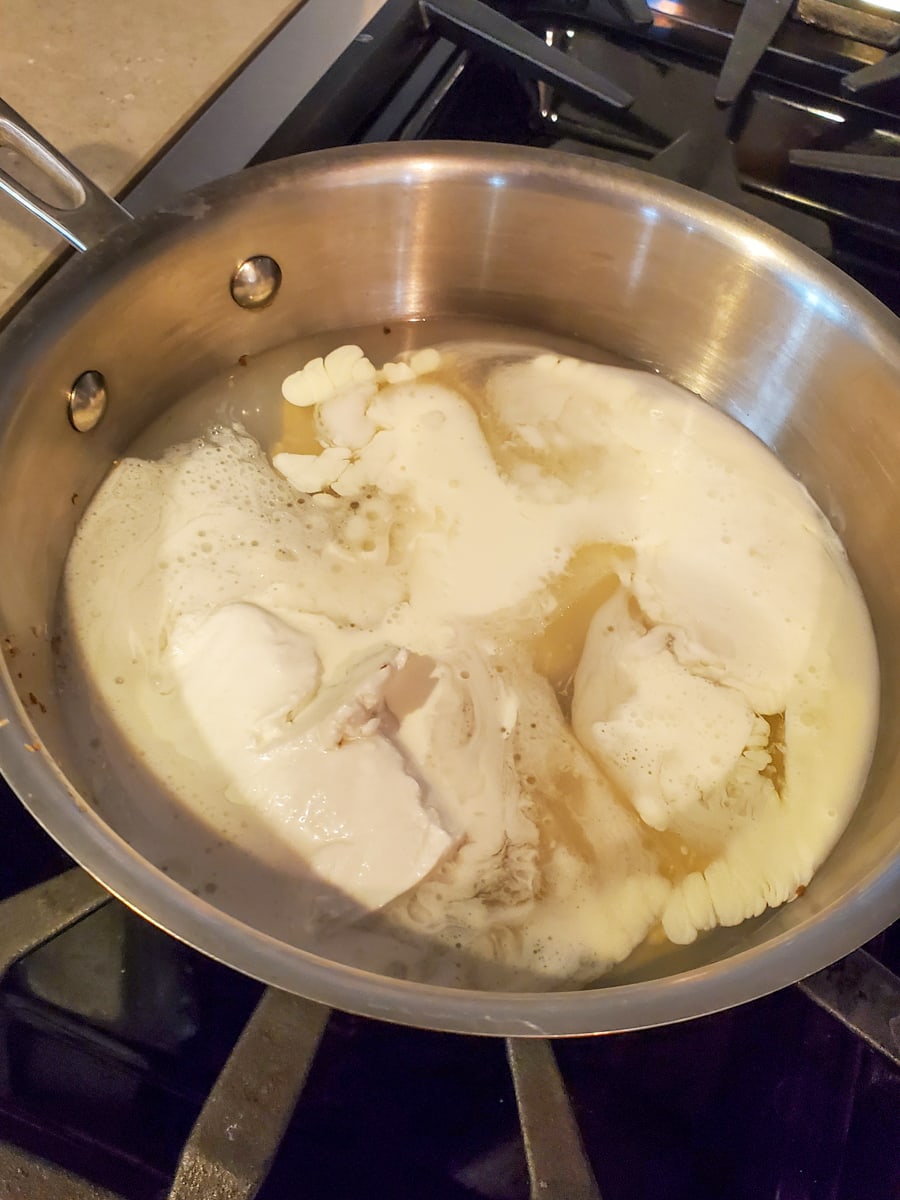 Coconut milk heating in a pan.