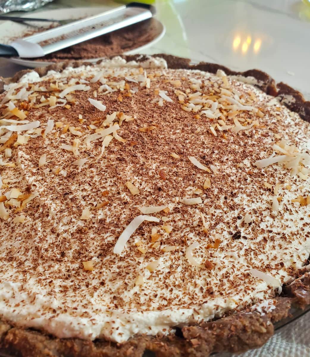 Coconut cream pie topped with grated chocolate and toasted coconut.