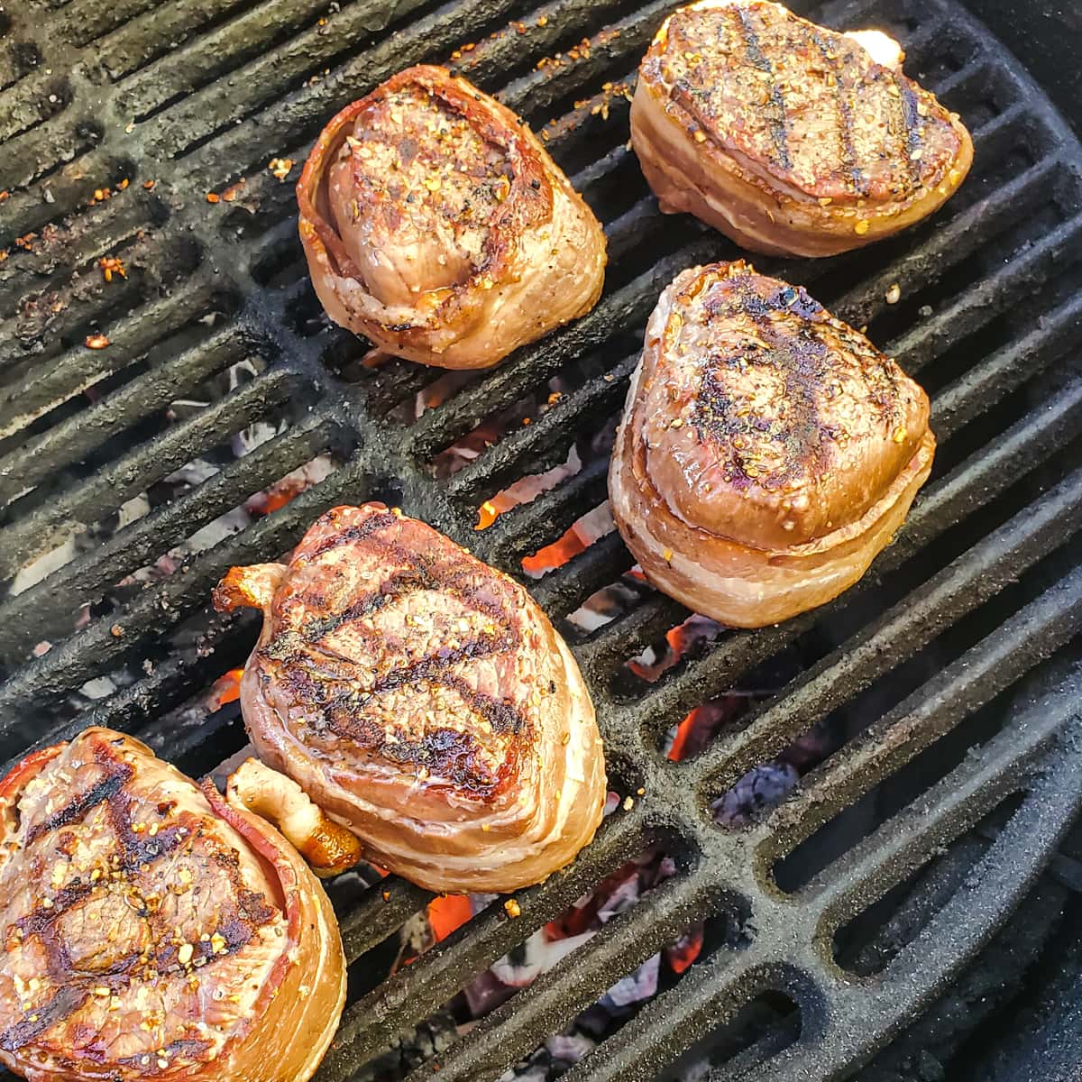 Bacon wrapped filet mignon on a Big Green Egg grill.