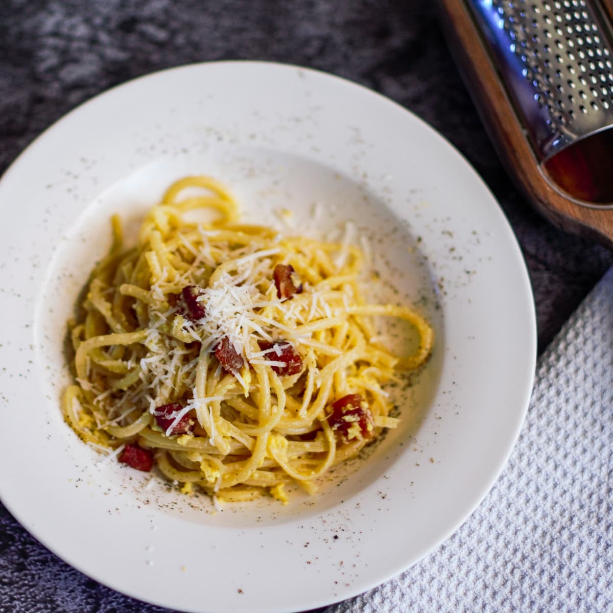 Italian carbonara pasta with fried guanciale.