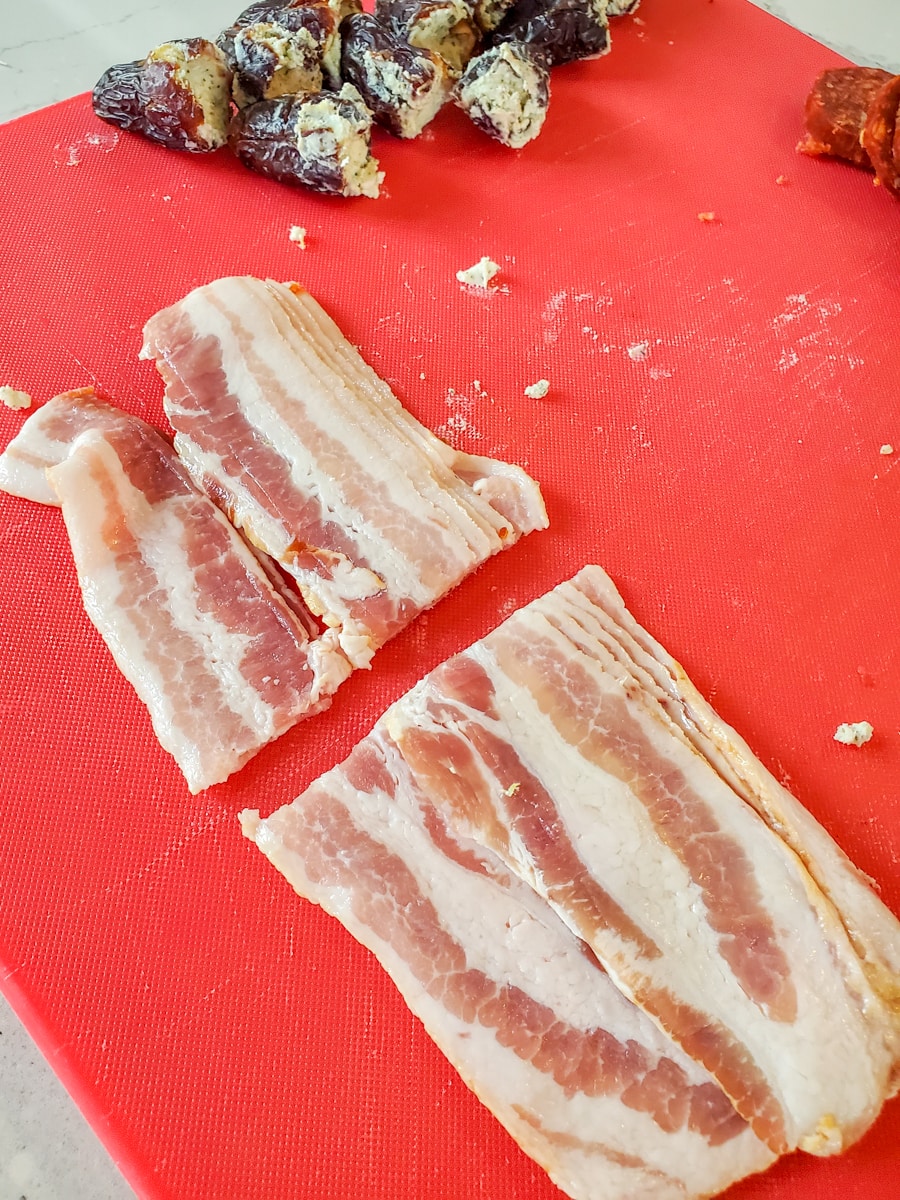 Slices of bacon cut in half.