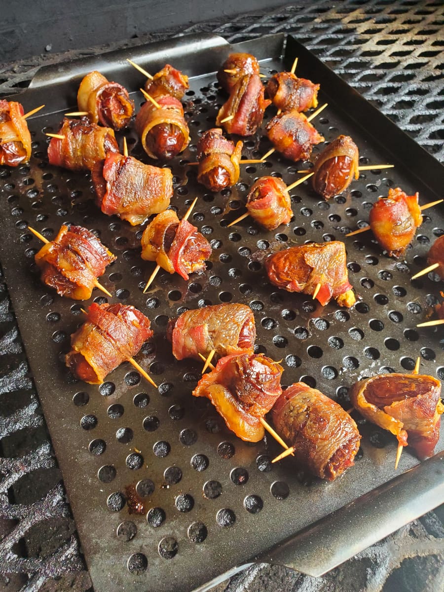 Grilled bacon wrapped dates stuffed with chorizo and goat cheese.