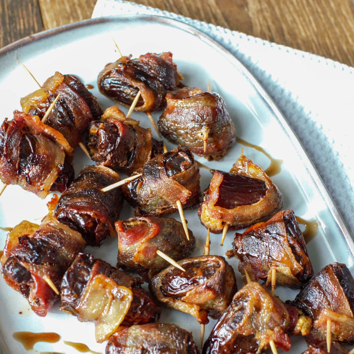 Grilled bacon wrapped dates stuffed with chorizo: Devils on Horseback appetizer.