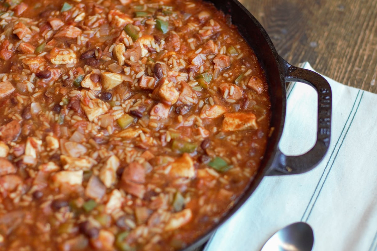 Southern Style Jambalaya with sausage and chicken in a cast iron pan.