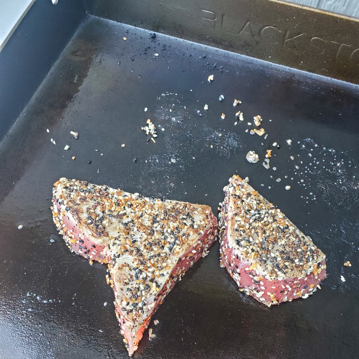 Cooking Ahi Tuna, seasoned with Everything Bagel Seasoning on a Blackstone Griddle.