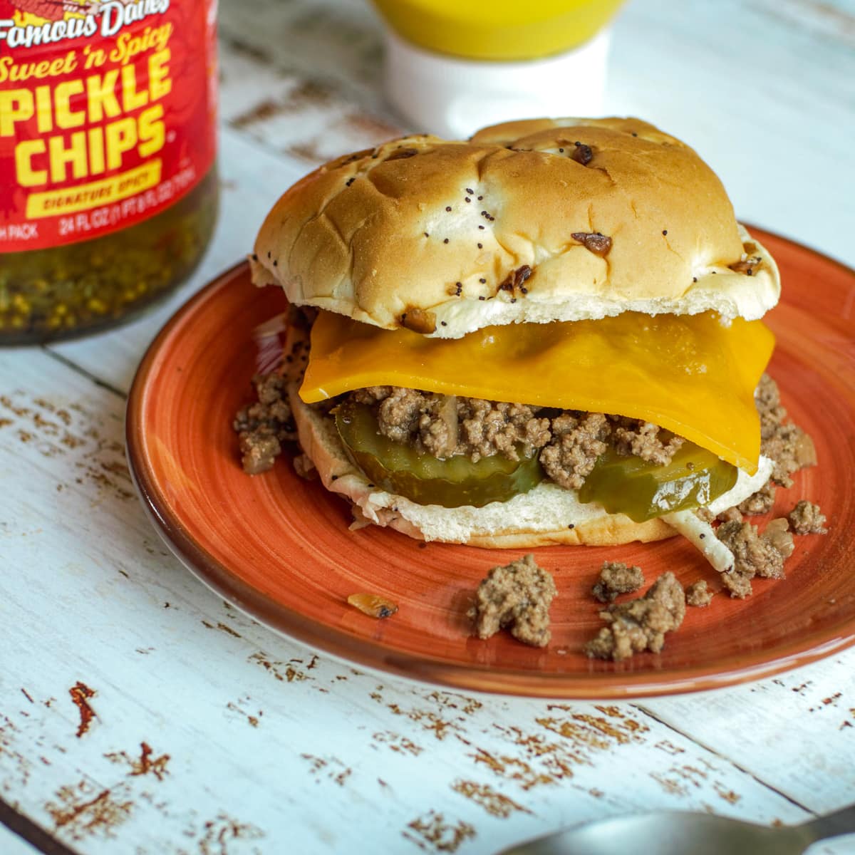 Dutch Oven Maid Rite Sandwich topped with cheese, on an onion bun.