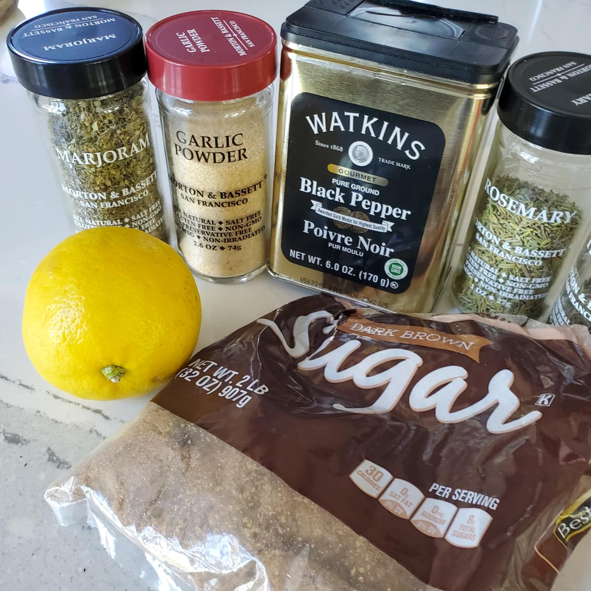 Ingredients for salmon seasoning, including brown sugar, garlic powder, pepper, and rosemary.