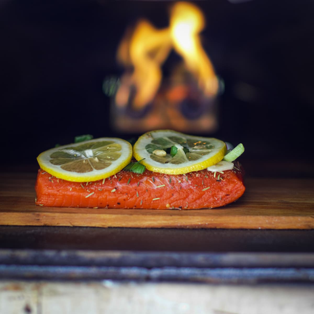 Wood plank salmon in a wood fire pizza oven.
