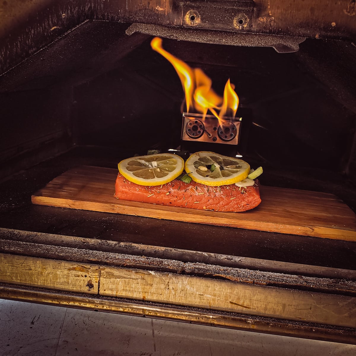 Cedar plank sockeye salmon in a Ooni pizza oven.