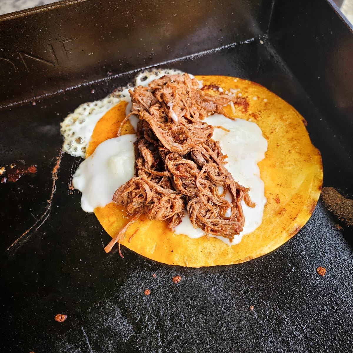 Making Quesabirria tacos with leftover brisket on a Blackstone.