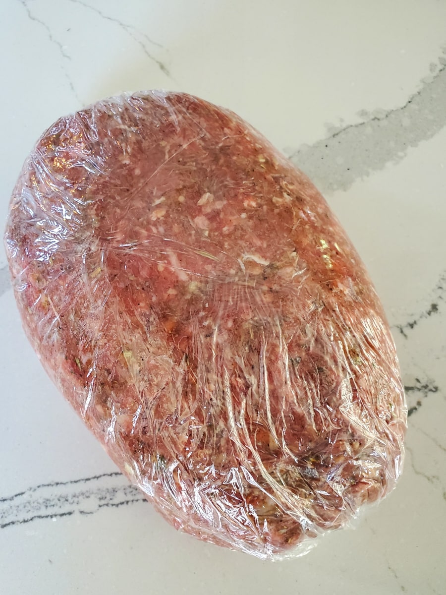 Homemade gyro meat wrapped in plastic wrap.