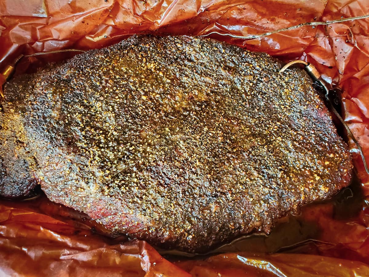 Venting a smoked brisket wrapped in Butcher's paper.