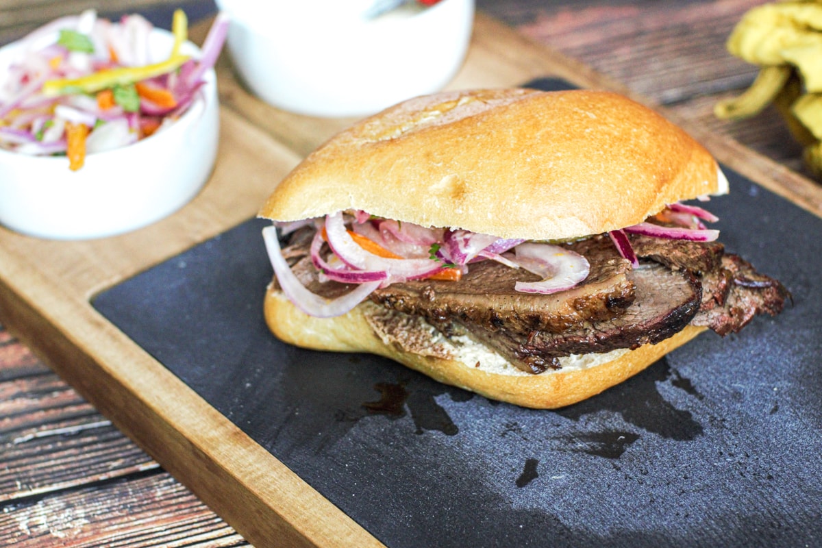 Grilled steak sandwich with picanha and salsa criolla.