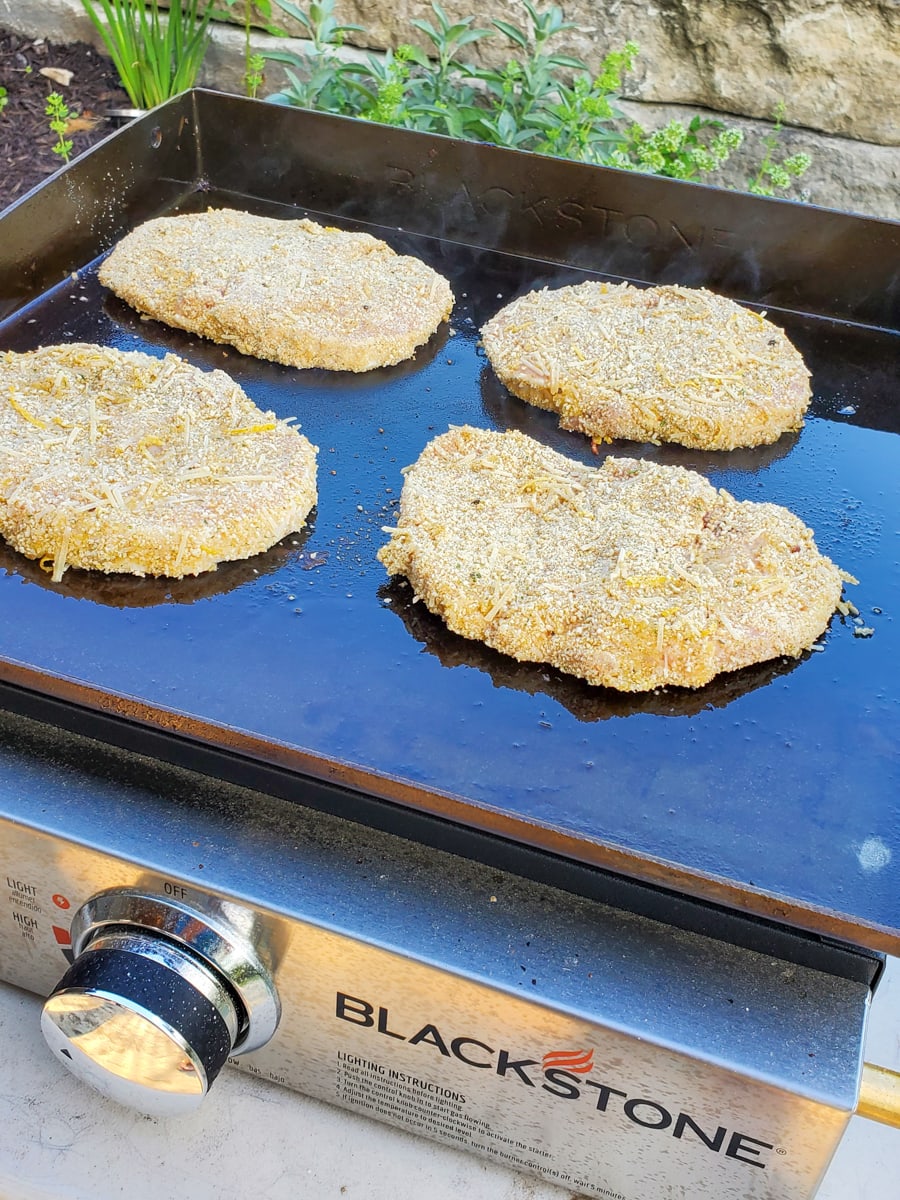 Breaded Italian pork chops on a Blackstone griddle.