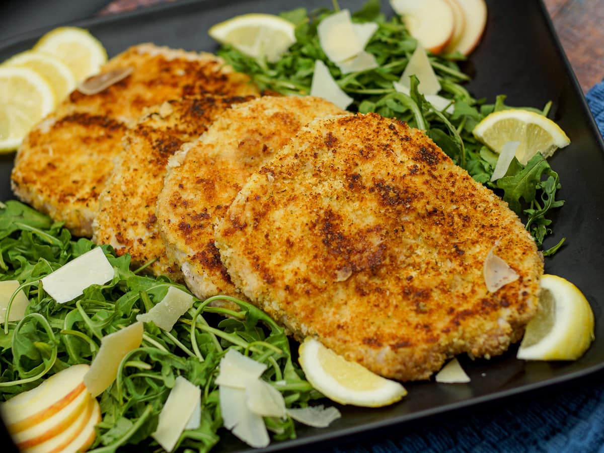 Breaded Pork Milanese served over arugula salad.