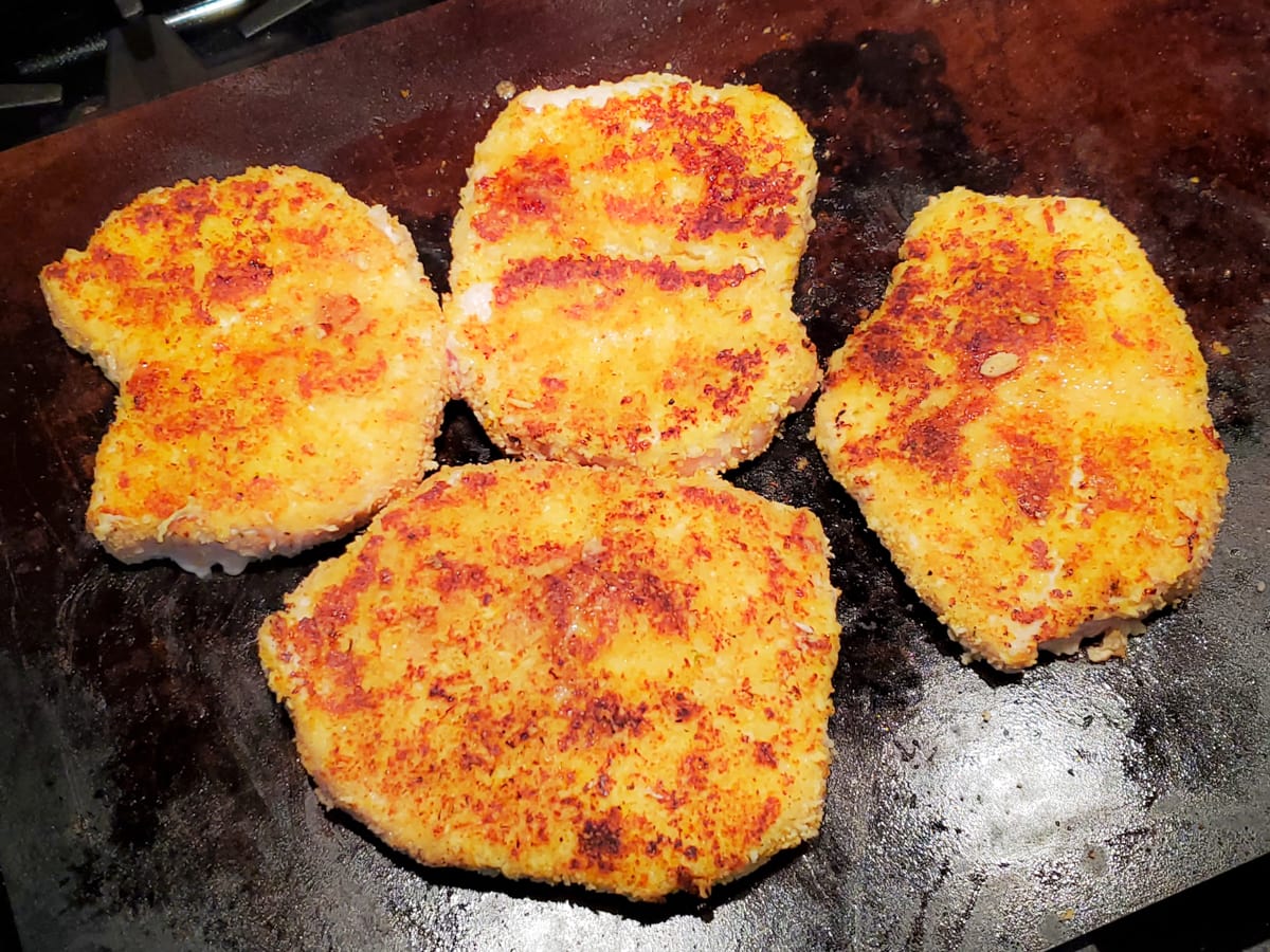 Pork Milanese on a flattop griddle.