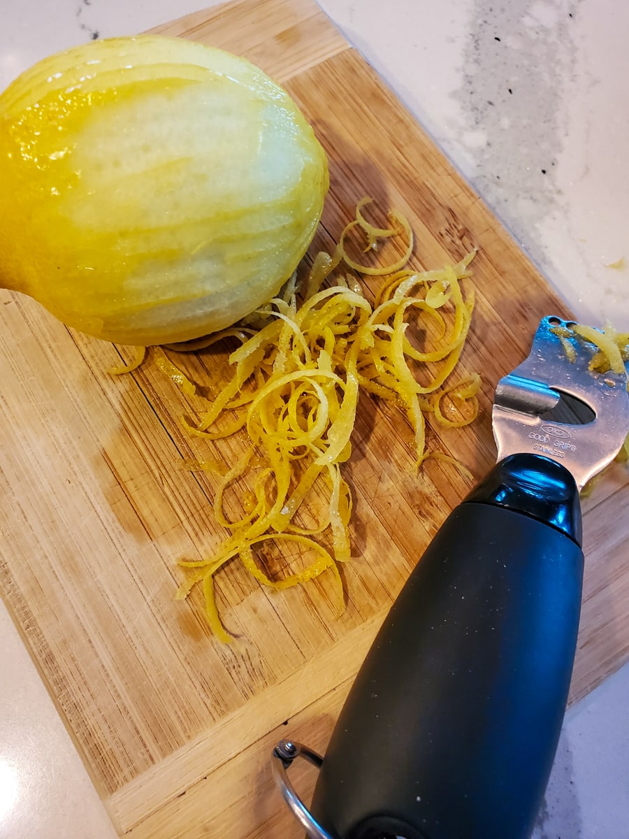 Grated lemon zest on a cutting board.