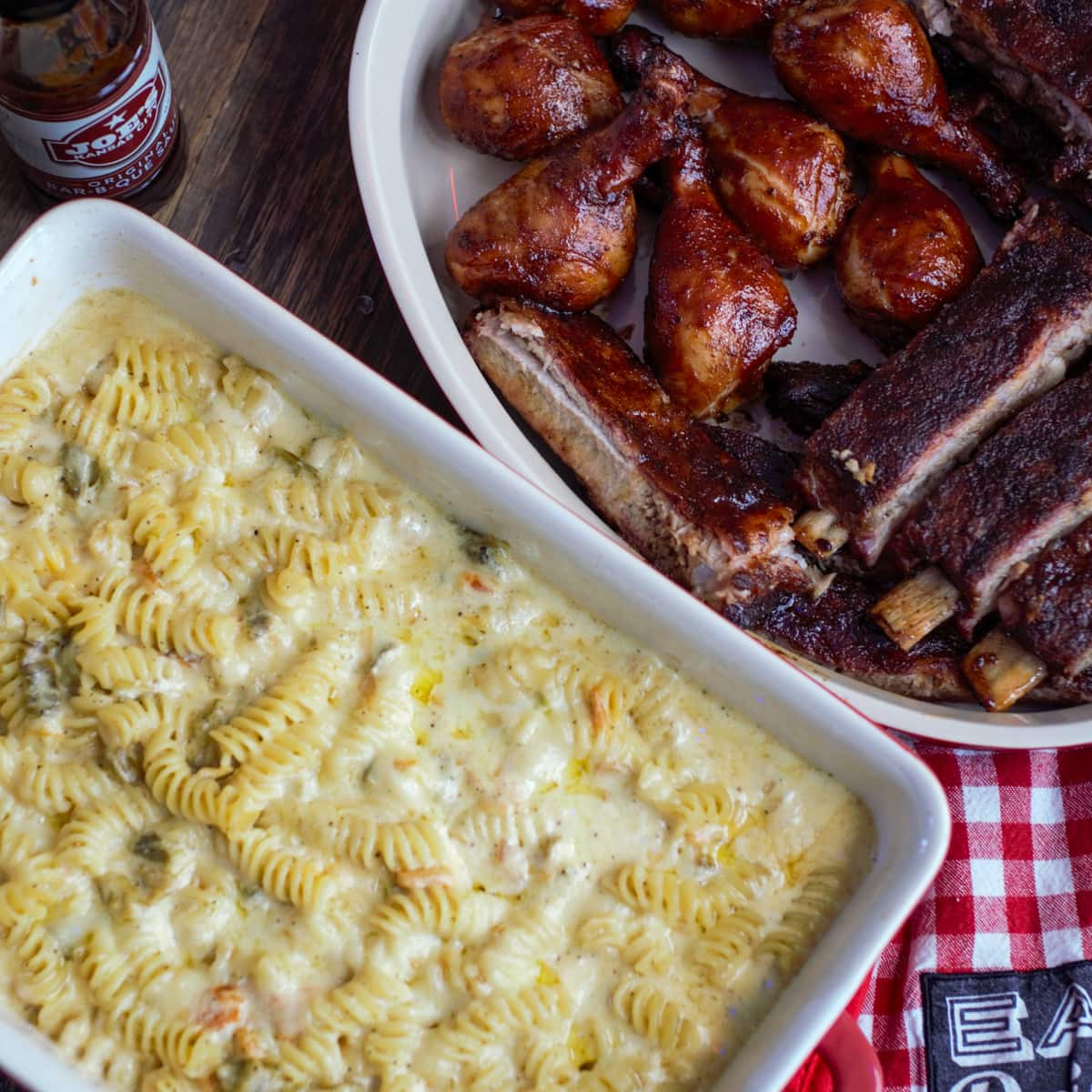 Table with barbequed meats and smoked cheesy mac.