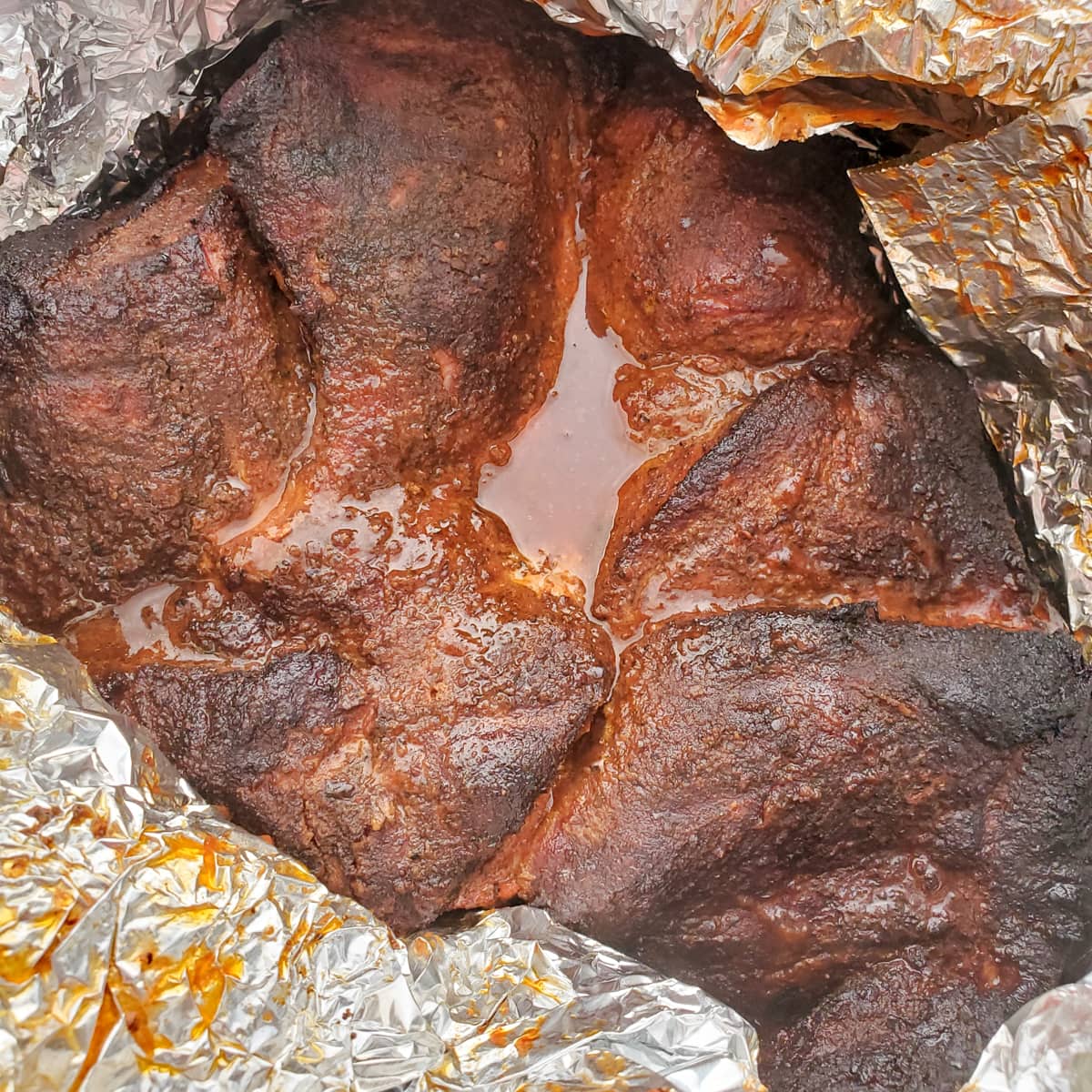 Boneless pork butt wrapped in foil.