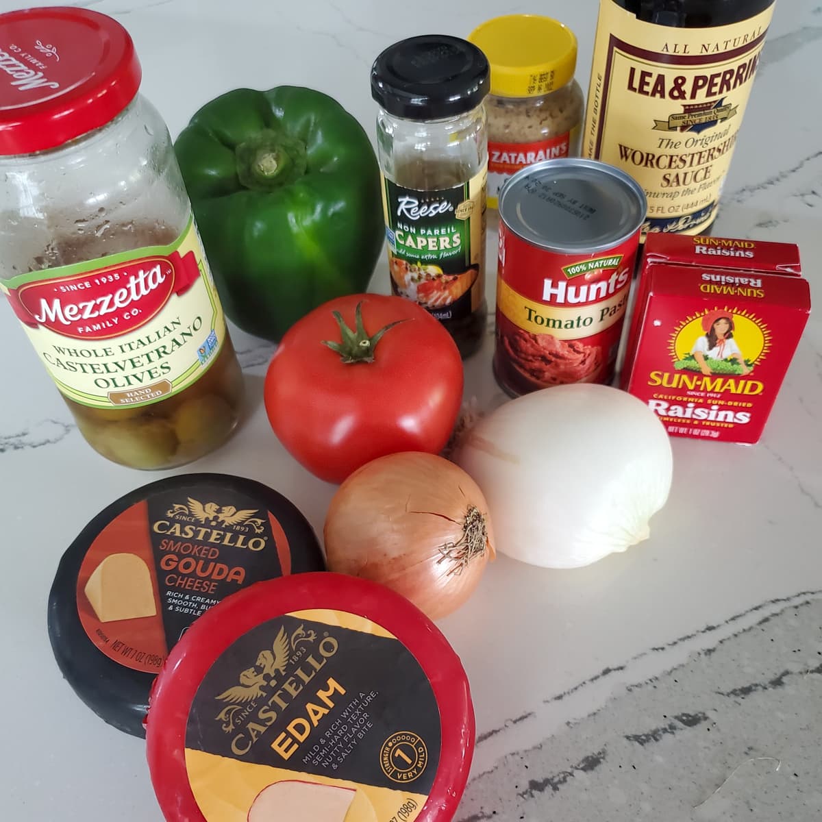 Ingredients for making Keshi Yena, on a countertop.