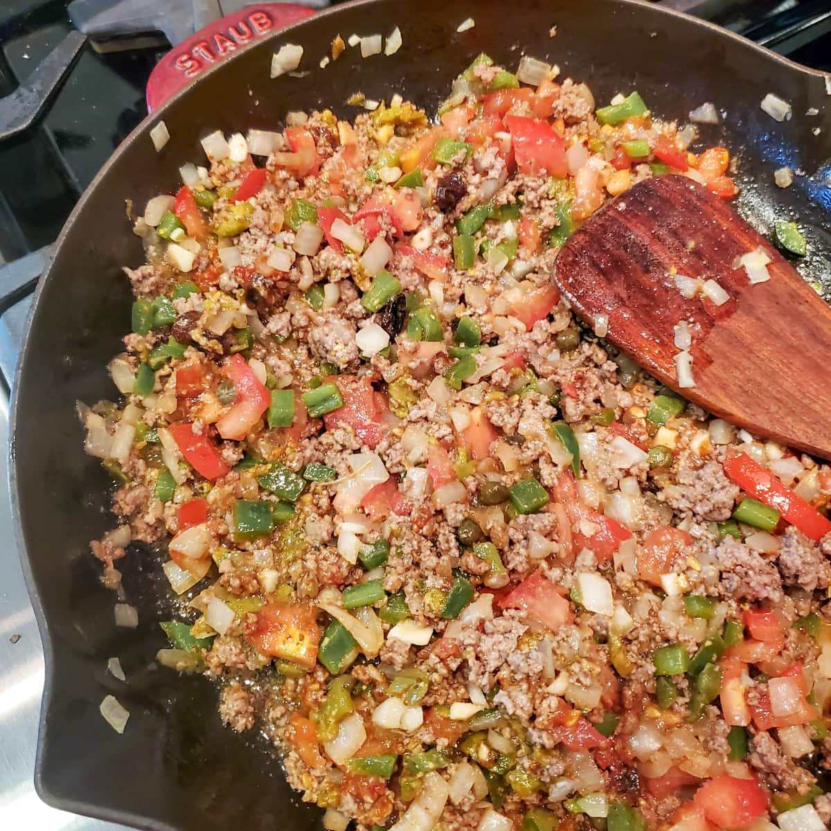 Keshi Yena filling cooking in a skillet.