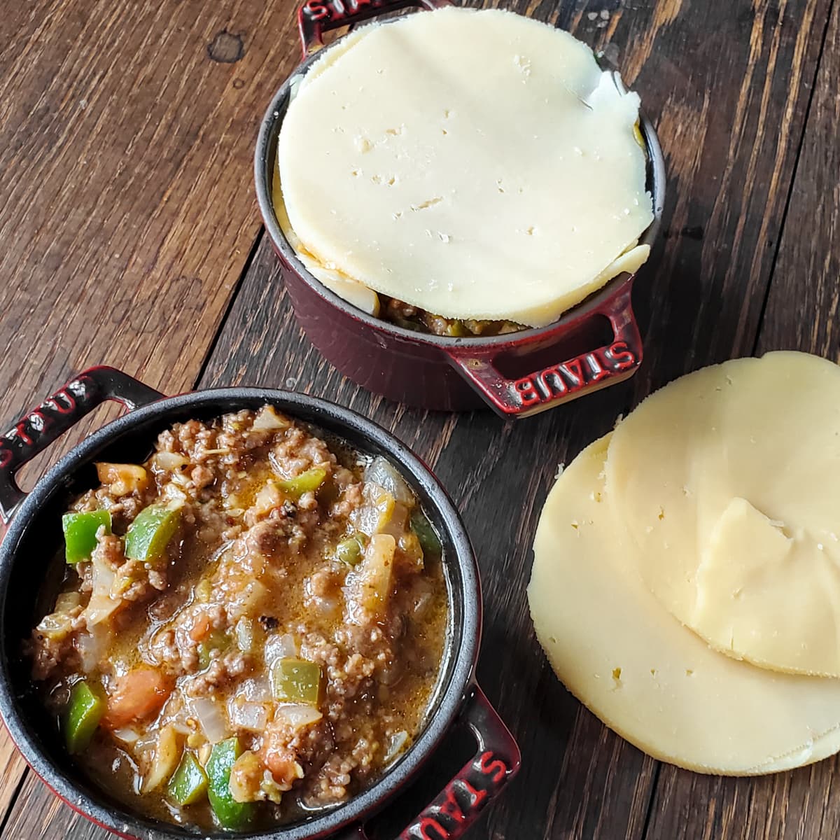 Meat filling being added to Gouda stuffed cheese.