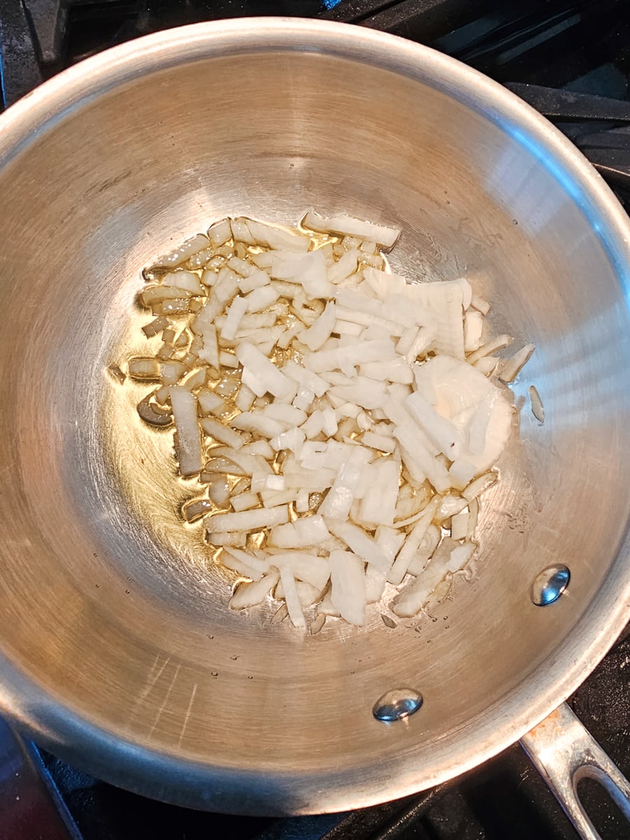 Garlic and onion sautéing in a pan.