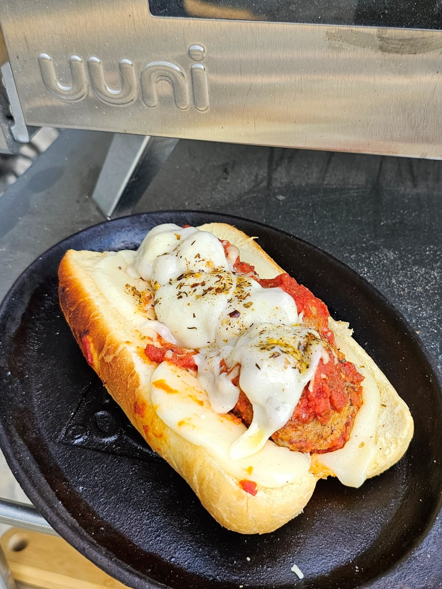 Wood fire cooked meatball grinder with Sicilian meatballs, homemade marinara, and melted provolone.