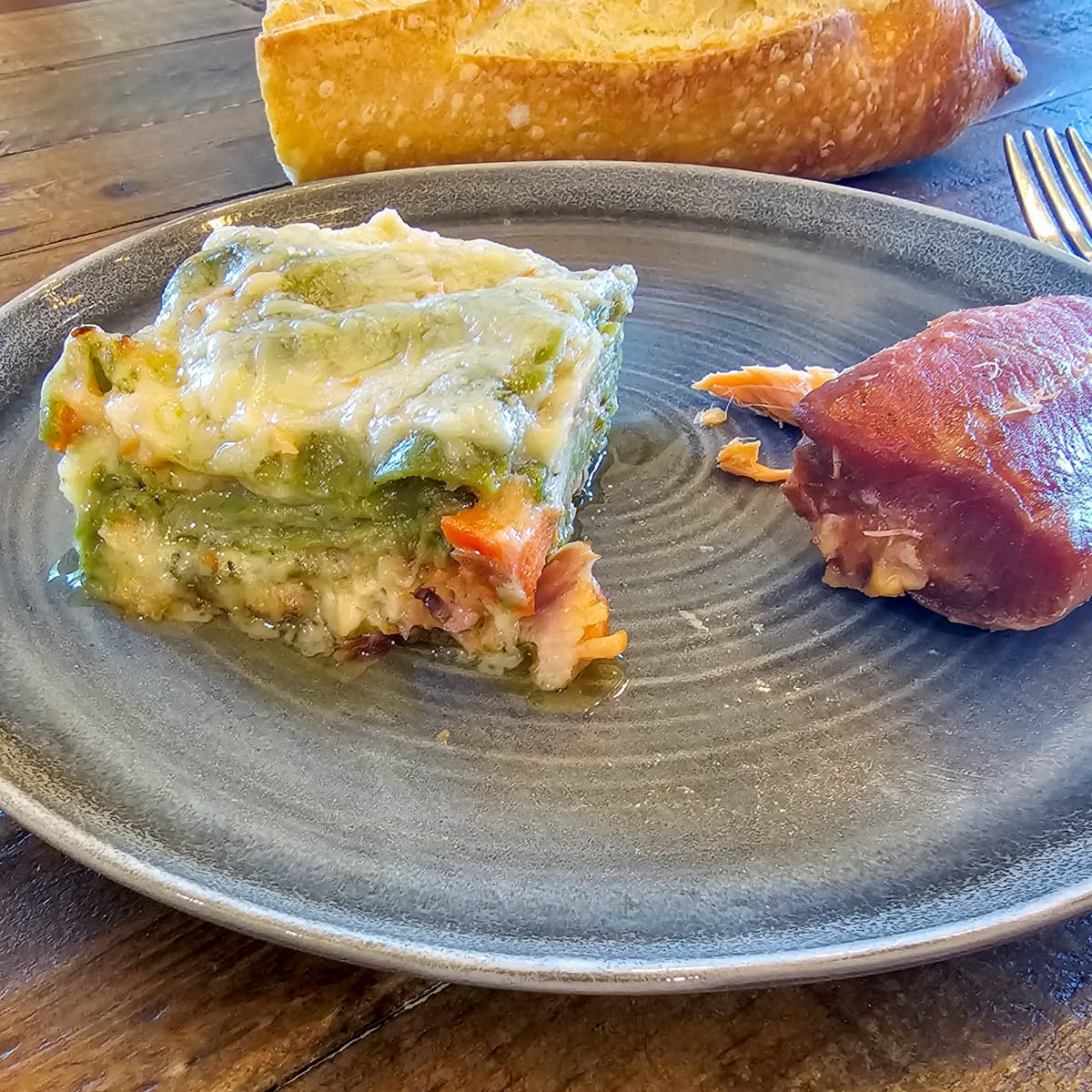 Seafood lasagna with smoked salmon, spinach noodles and parmesan bechamel sauce.