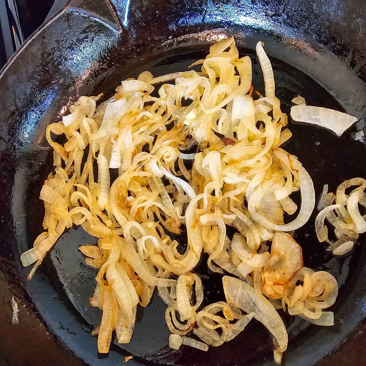 Onion caramelizing in a pan.