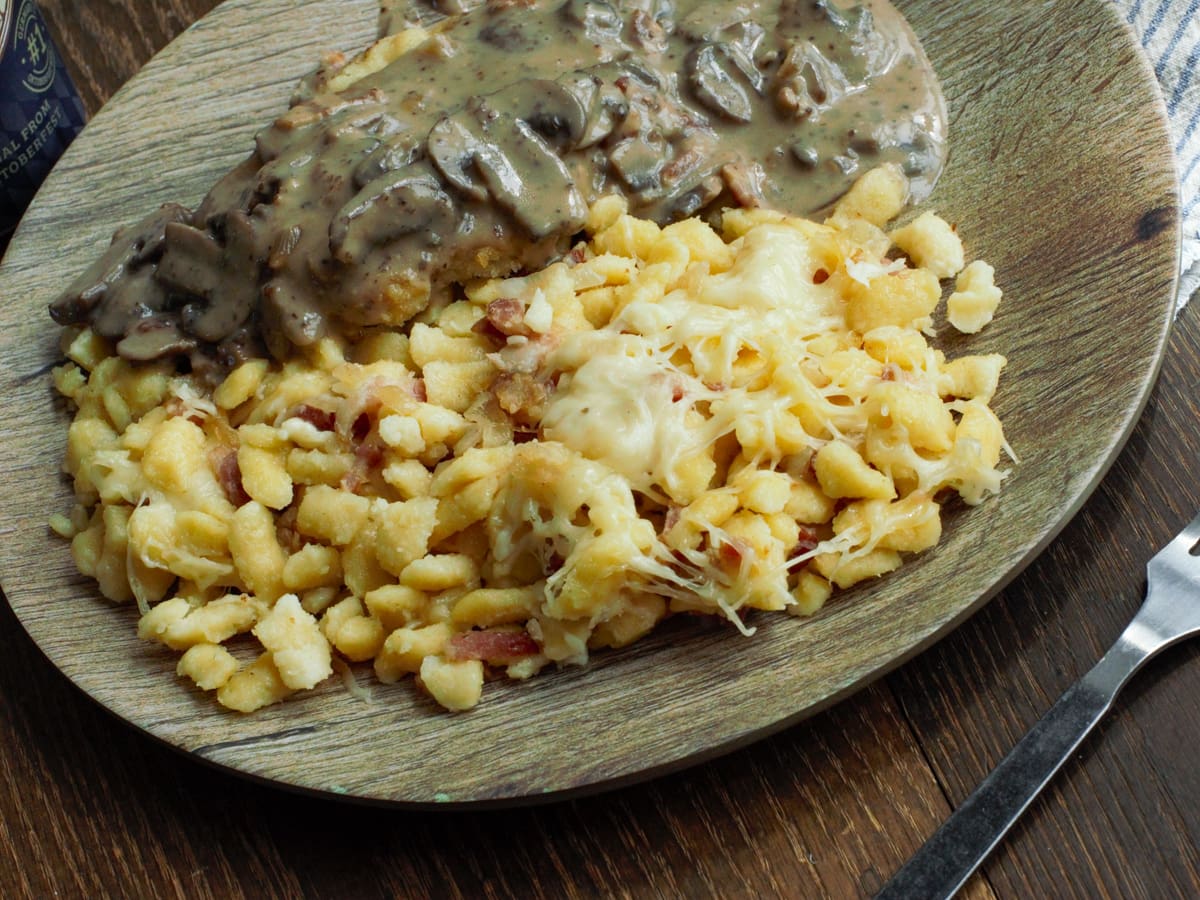 German spatzle with bacon, cheese and caramelized onion served with Hunter Schnitzel.