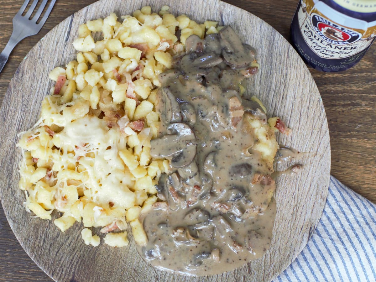 Cheesy Kasespaetzle with bacon served with Jagerschnitzel.