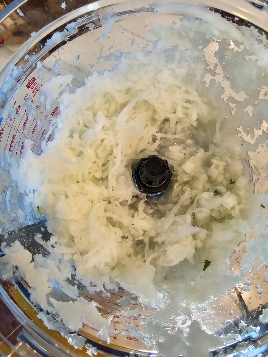 Shredded onion in a food processor.