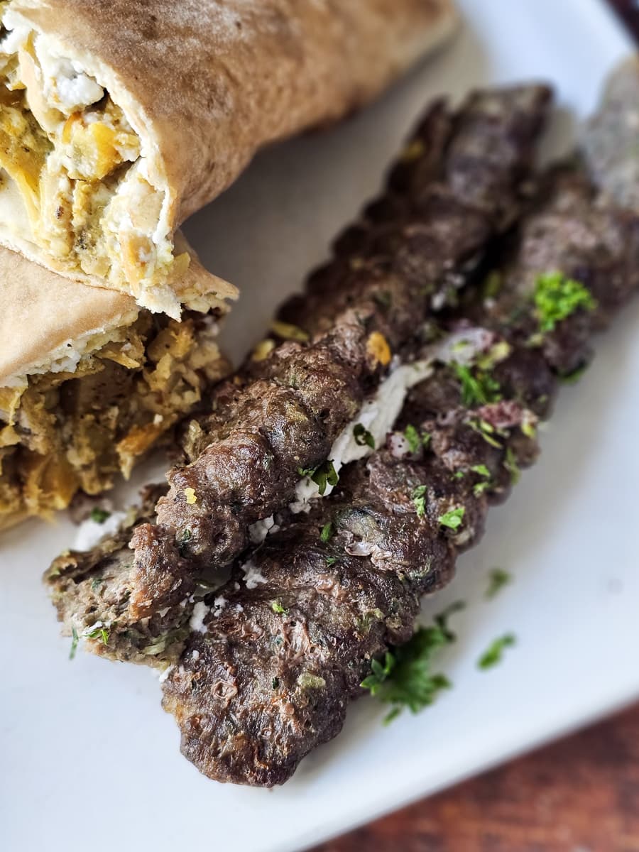 Grilled Moroccan kefta on a plate.