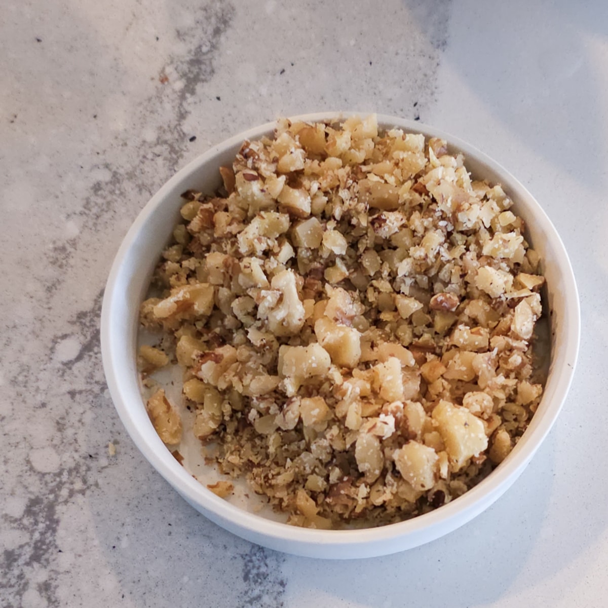 Chopped walnuts in a bowl.