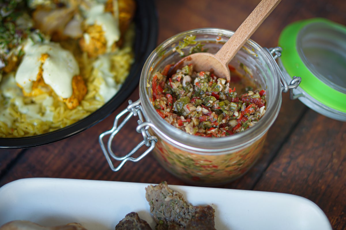 Middle Eastern shatta hot pepper sauce in a glass jar.