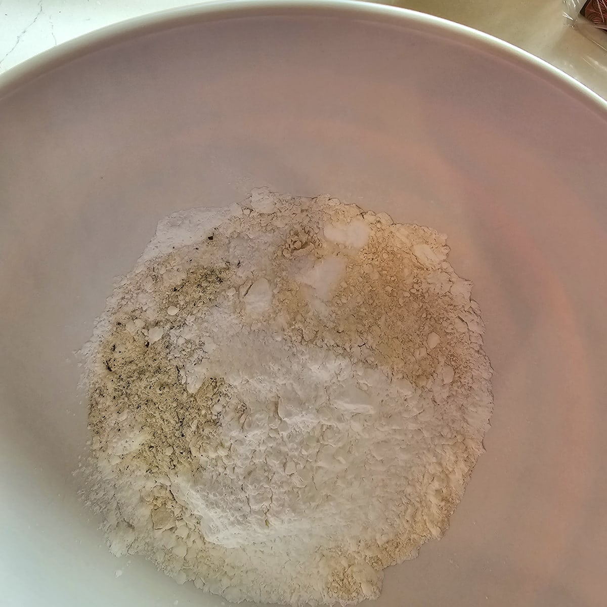 Flour, cornstarch, and seasoning in a bowl.