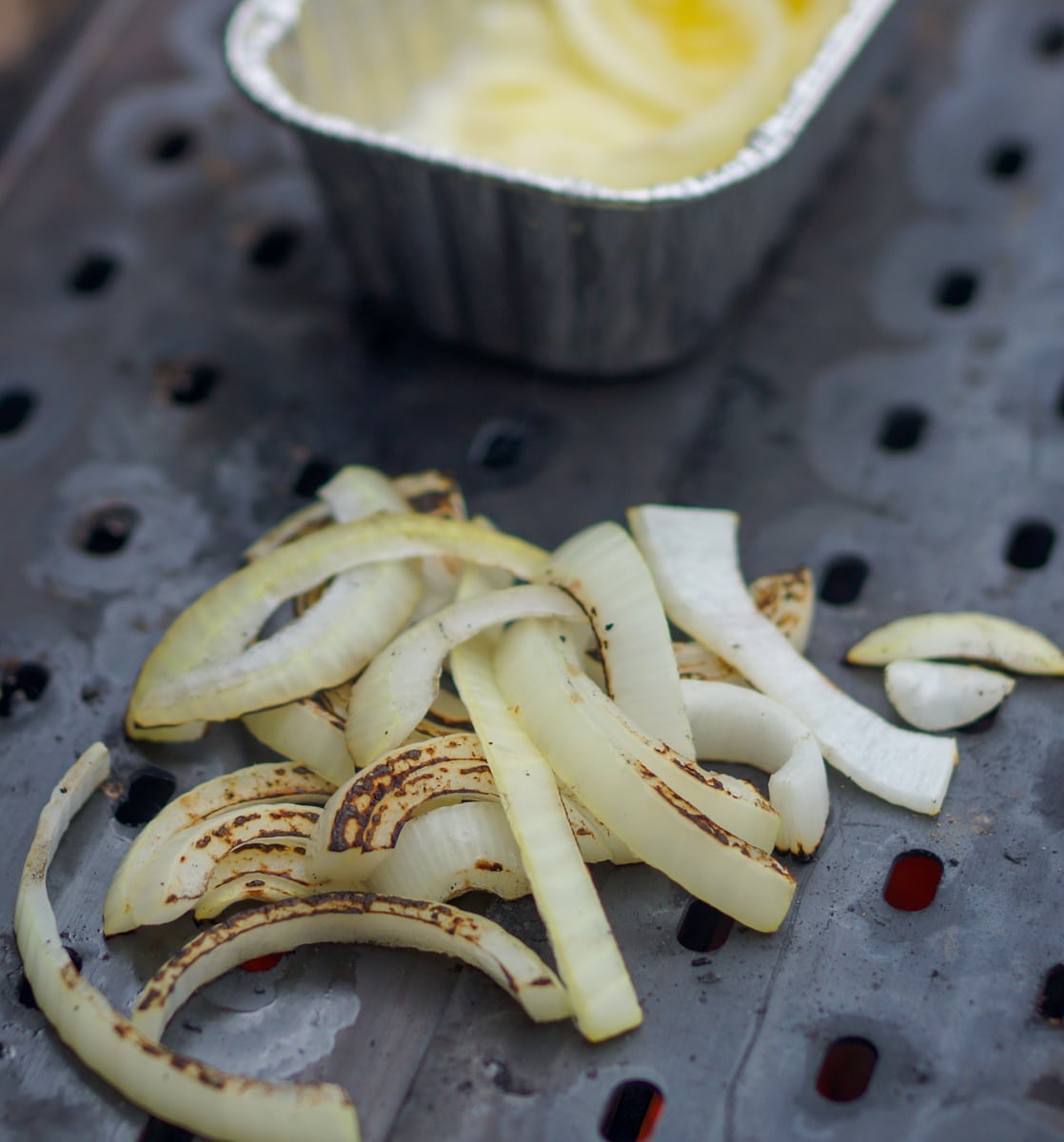 Onions cooking on a grill.